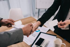 cropped view of business partners shaking hands an SUBGQMC